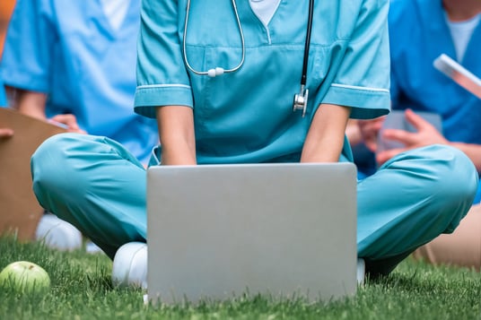 cropped-image-of-medical-student-studying-with-lap-JSZ8VV6
