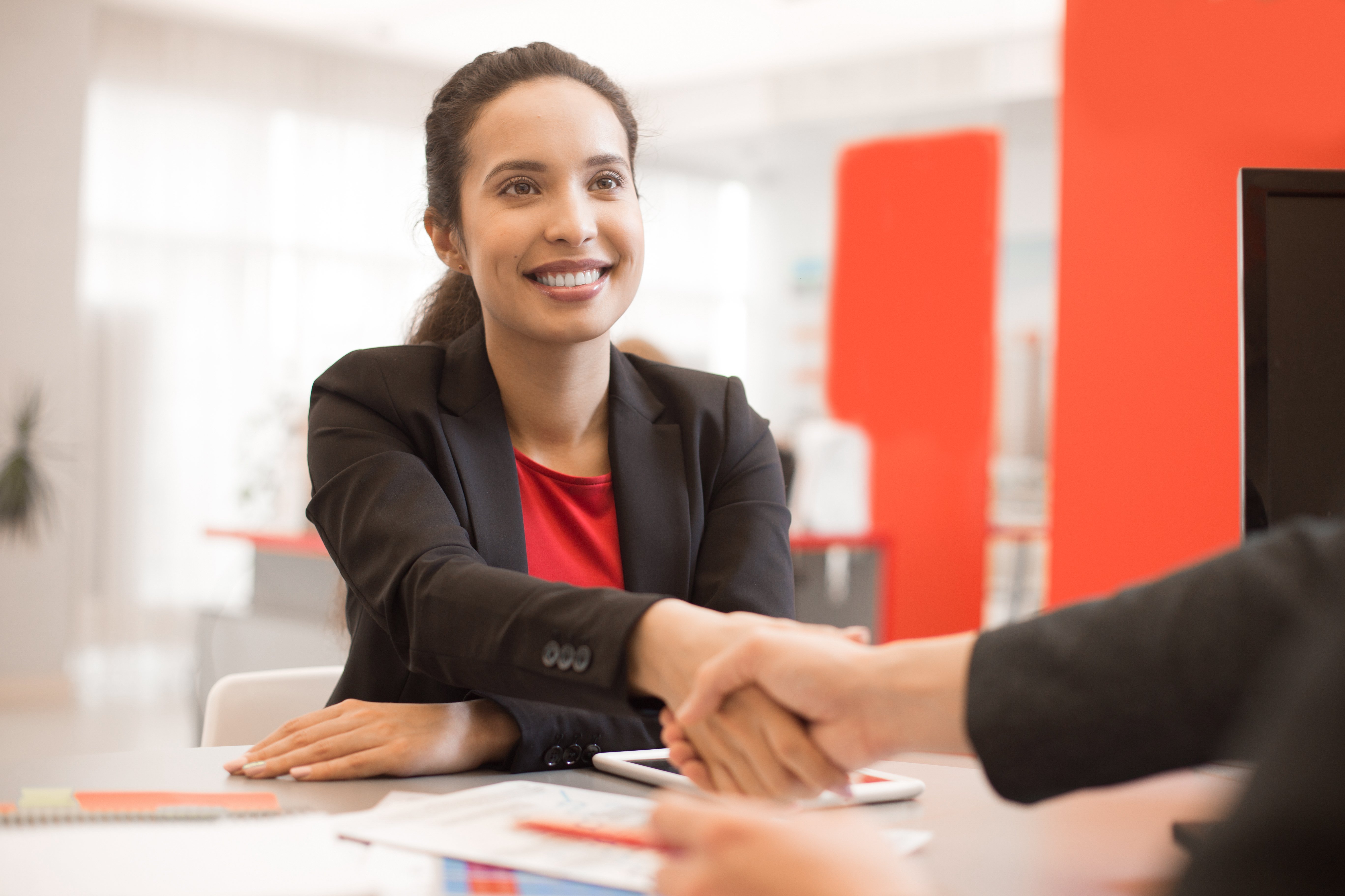 latin-businesswoman-shaking-hands-with-partner-D2TWSCX